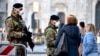 Italian soldiers wearing sanitary masks patrol Duomo square in downtown Milan, Italy, Feb. 24, 2020.