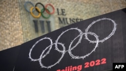 西藏新疆活動人士在洛桑用鐵絲網編織奧運圓環抗議中國2022年主辦北京冬奧會。 （法新社2021年6月23日）