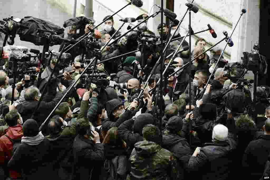 Journalists gather upon the arrival of leader of the right-wing party Forza Italia, Silvio Berlusconi (not in picture) at Palazzo Montecitorio, the seat of the lower house of parliament in Rome, Italy, for a meeting with ex-central banker Mario Draghi.