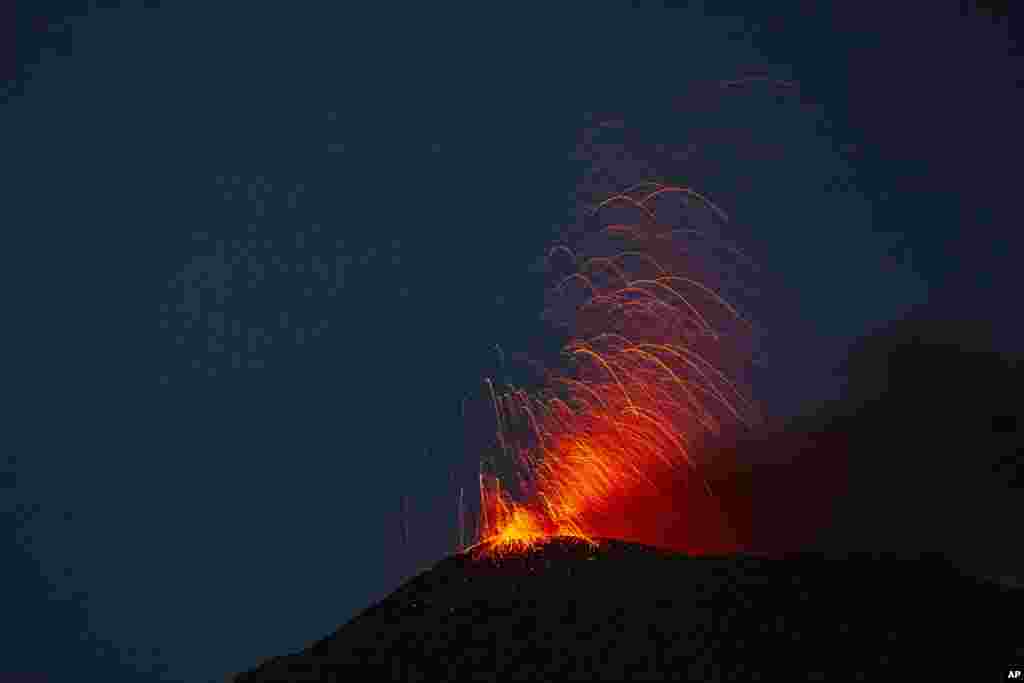 Pacaya volcano spews lava, viewed from San Vicente Pacaya, Guatemala, July 25, 2020.