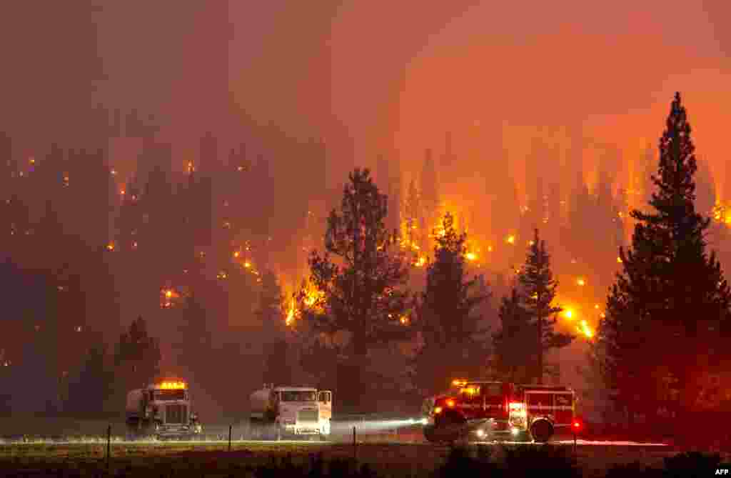Firefighters mop up hot spots from the Hog Fire along highway 36 about 5 miles from Susanville, California, July 20, 2020.