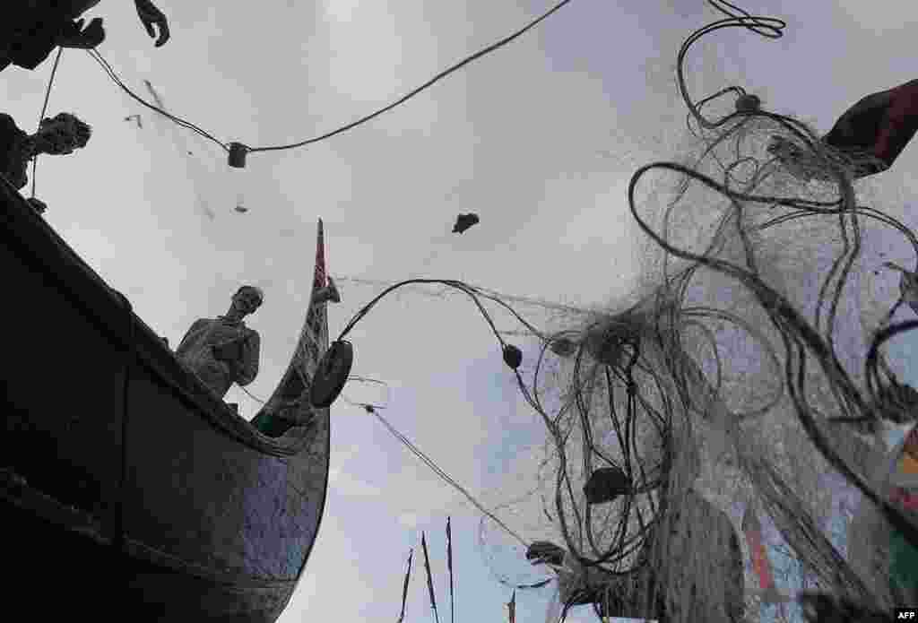 Fishermen prepare their nets after fishing in the sea in Shamlapur, some 50 km from Cox's Bazar, Bangladesh.