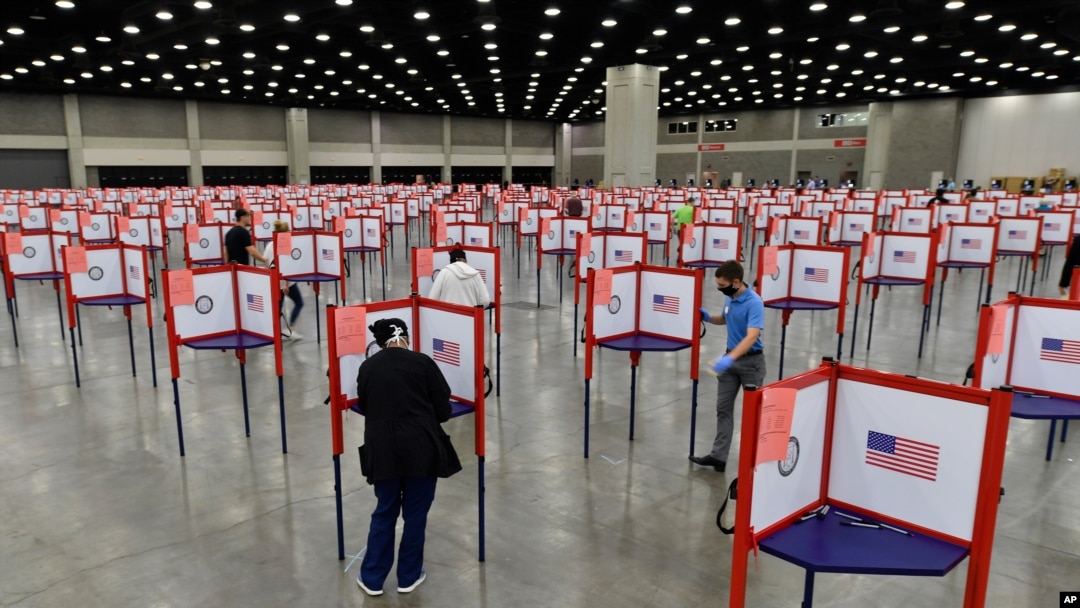 FILE - Voting stations are set up in the Kentucky Exposition Center for voters to cast their ballot in the Kentucky primary in Louisville, Ky., June 23, 2020. 