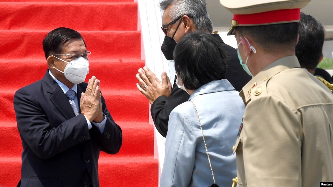 Myanmar's junta chief Senior General Min Aung Hlaing (L) gestures as he is welcomed upon his arrival ahead of the ASEAN leaders' summit, at the Soekarno Hatta International airport in Tangerang, on the outskirts of Jakarta, Indonesia, April 24, 2021. Cour