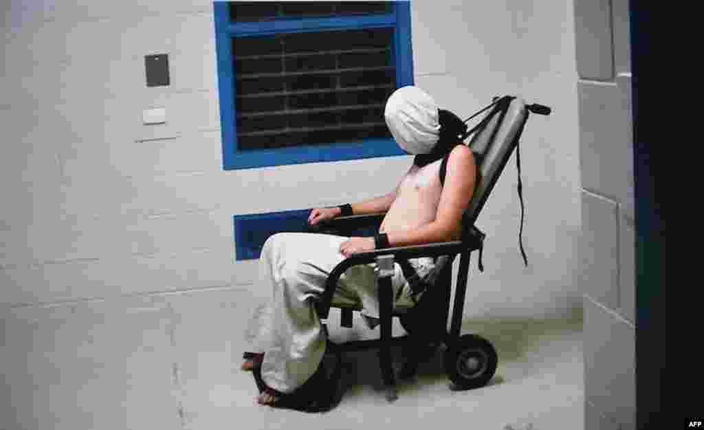 This frame grab from Australian Broadcasting Corporation's (ABC) Four Corners program broadcast on July 25, 2016, allegedly shows a teenage boy hooded and strapped into a chair at a youth detention center in the Northern Territory city of Darwin. The Australian government ordered an inquiry after graphic evidence emerged of prison guards assaulting teenage boys, with one shown hooded and shackled in scenes likened to Guantanamo Bay.