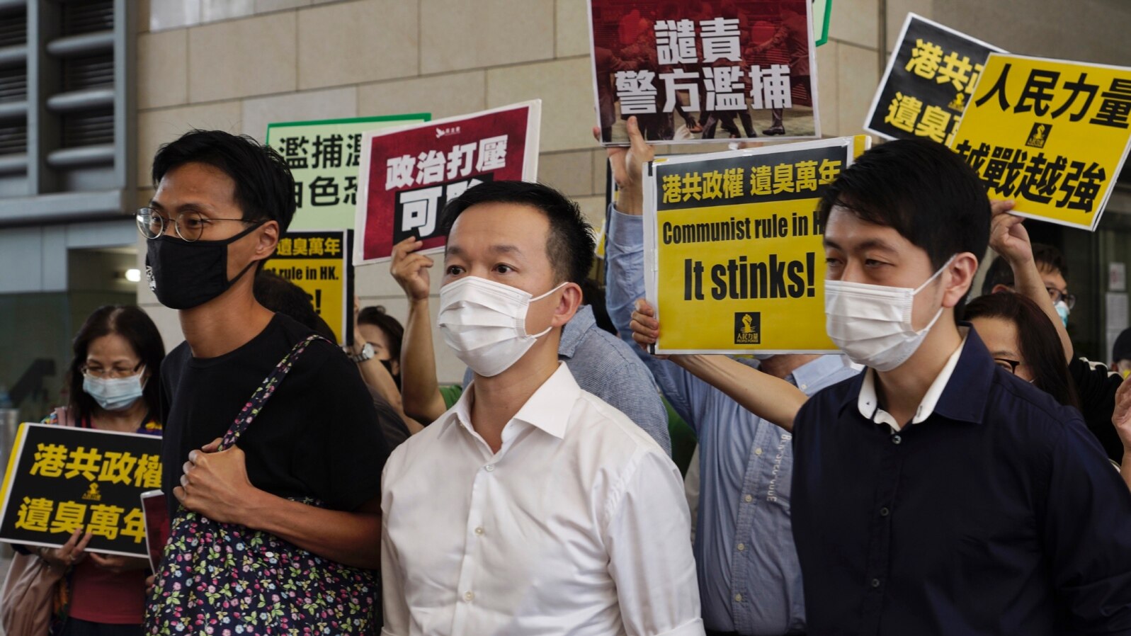 FILE - Pro-democracy lawmakers, from left; Eddie Chu, Raymond Chan and Ted Hui walk with supporters at a local court in Hong Kong, Nov. 19, 2020.