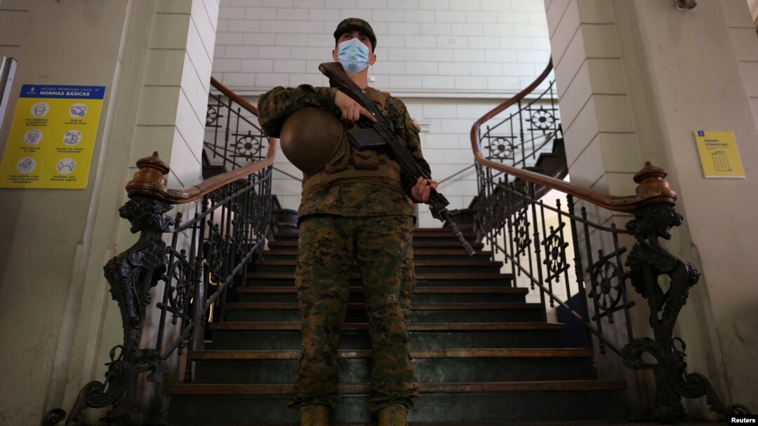 A soldier stands guard inside a polling station ahead of the upcoming presidential election in Santiago, Chile, Nov. 19, 2021. 