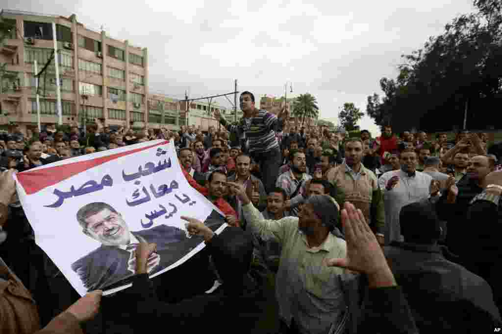 Supporters of Egyptian President Mohammed Morsi chant slogans during a demonstration outside the presidential palace, in Cairo, Egypt, Dec. 5, 2012.