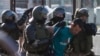 Belarusian law enforcement officers detain a man during a rally following the presidential election in Minsk, Aug. 11, 2020.