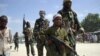 FILE - A young boy leads militant Islamist al-Shabab fighters as they conduct military exercises in northern Mogadishu's Suqaholaha neighborhood, Somalia, Jan. 1, 2010. Dozens of children kidnapped by al-Shabab and being trained as fighters were rescued from a school in the Middle Shabelle region, Somali's information minister said Friday.