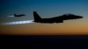 FILE - A pair of U.S. Air Force F-15E Strike Eagles fly over northern Iraq after conducting airstrikes in Syria, in this U.S. Air Force handout photo.