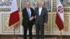 Iranian Foreign Minister Mohammad Javad Zarif, right, and his French counterpart Jean-Yves Le Drian, shake hands for journalists at the start of their meeting in Tehran, March 5, 2018. 