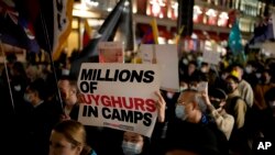 FILE - Demonstrators supporting Tibetans, Uyghurs and Hong Kongers take part in a protest against the Chinese Communist Party (CCP) to coincide with the 72nd National Day of the People's Republic of China, as they march along Regent Street towards the Chi