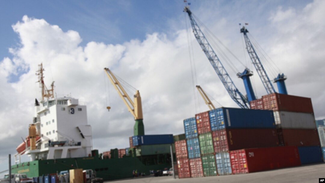 Shipping containers beside a cargo ship at the Port of Miami, Fla., Feb. 4, 2011 (file photo).