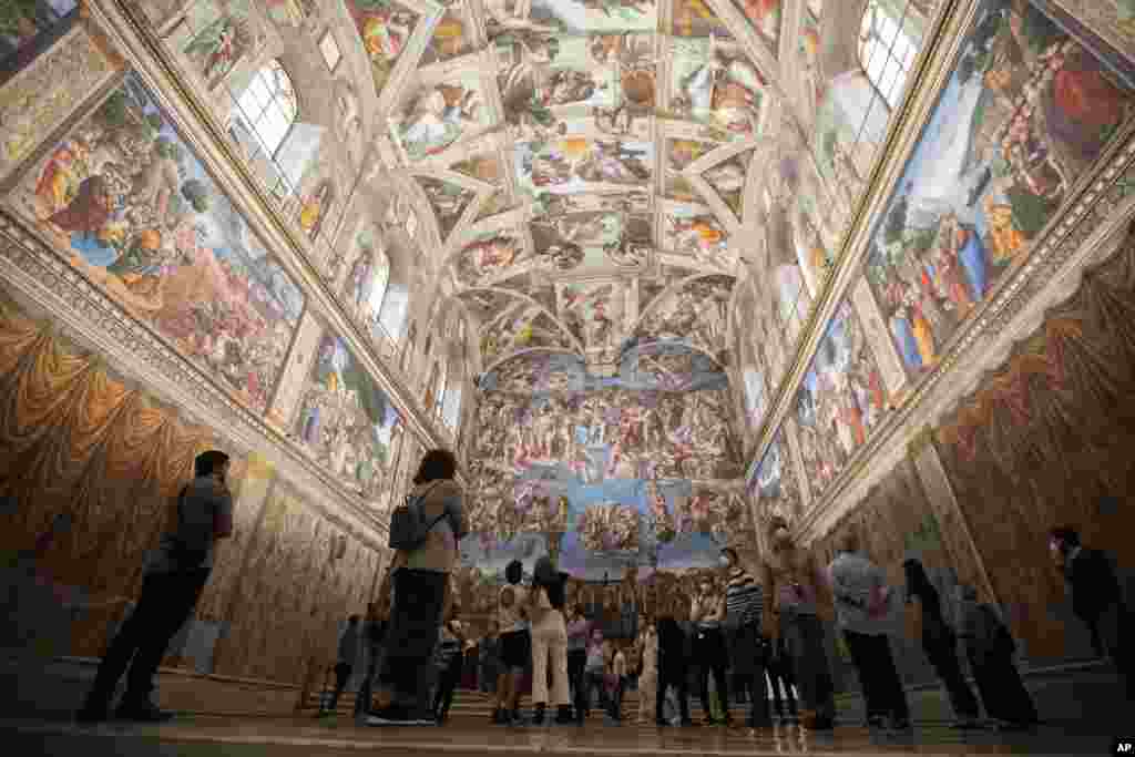 Visitors admire the Sistine Chapel as the Vatican Museum reopened, in Rome, Italy.