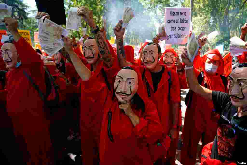 Nissan workers dressed in costumes from "La Casa de Papel (Money Heist)" take part in a protest outside Spanish parliament in Madrid.