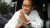 FILE - In this July 27, 2008 photo, Sam Rainsy leader of Sam Rainsy Party greets his supporters after casting his vote at a polling station in kampong Cham province north of Phnom Penh.