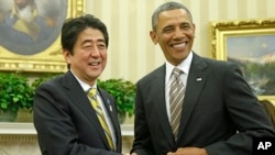 President Barack Obama shakes hands with Japan's Prime Minister Shinzo Abe in the Oval Office of the White House, Feb. 22, 2013. 