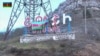 An image grab taken from a video made available on the official website of the Azerbaijani Defense Ministry Nov. 9, 2020, shows an Azeri flag on the side of a road entering the town of Shushi (Shusha) in the breakaway region of Nagorno-Karabakh.