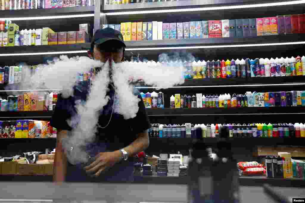 An employee vapes at a vape shop in Jakarta, Indonesia.