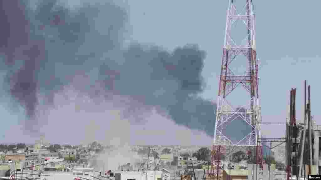 Smoke rises from what activists said was a missile fired by a Syrian Air Force fighter jet loyal to President Bashar al-Assad in Deraa, Syria, April 26, 2013.