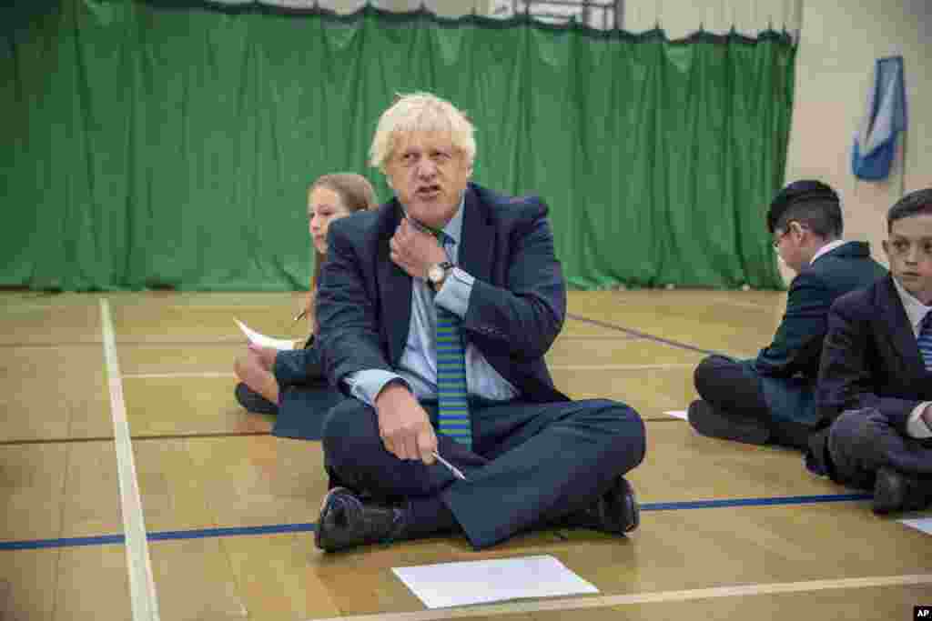 Britain's Prime Minister Boris Johnson gestures during a visit to Castle Rock school on the pupils' first day back, in Coalville, East Midlands, England.
