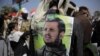 A Supporter of Houthi Shiites displays a poster of Abdel-Malek al-Houthi, the leader of Yemen's Shiite rebels, on his jacket during a rally to mark the third anniversary of the Houthis' takeover of the Yemeni capital, in Sanaa, Yemen, Sept. 21, 2017.
