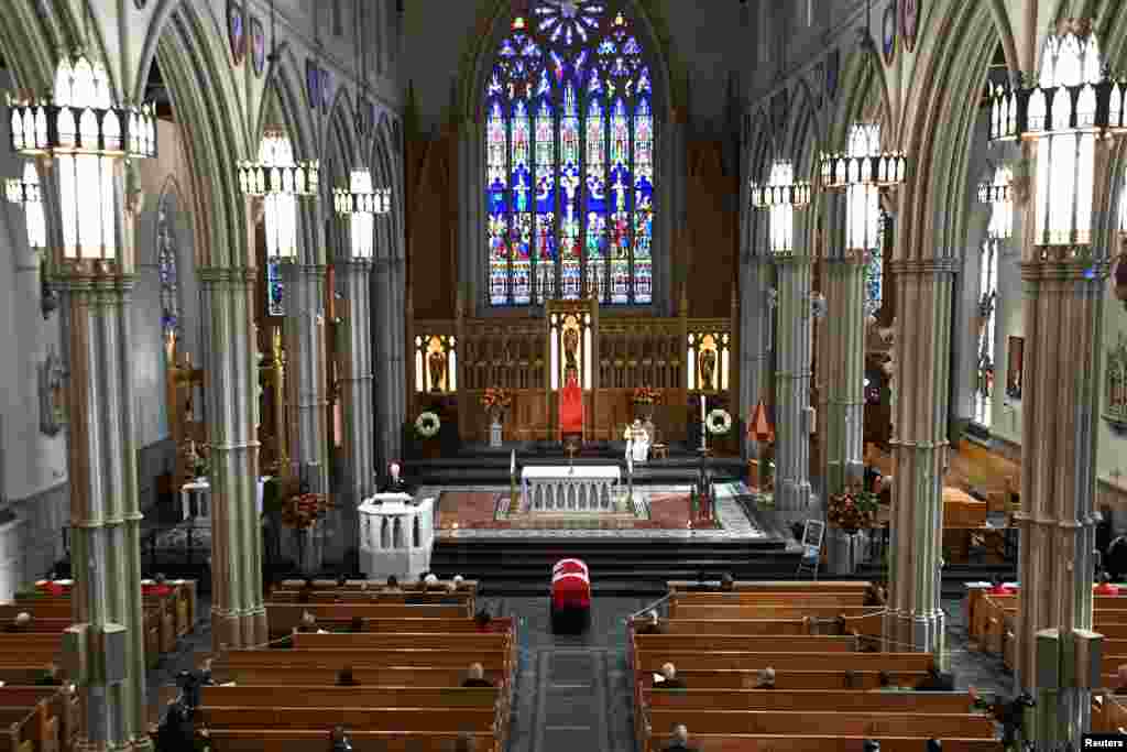 Mourners sit apart during the state funeral service for former Canadian prime minister John Turner at St. Michael's Cathedral Basilica in Toronto, Ontario.