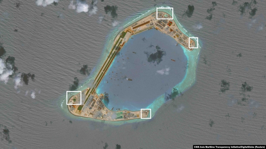 A satellite image shows what CSIS Asia Maritime Transparency Initiative says appears to be anti-aircraft guns and what are likely to be close-in weapons systems (CIWS) on the artificial island Subi Reef in the South China Sea in this image released on Dec