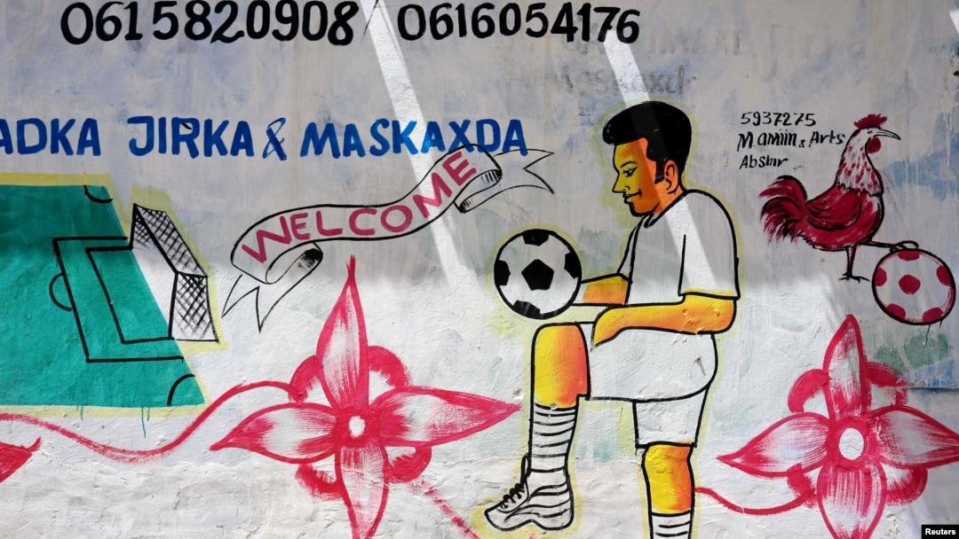 FILE - A mural depicting a soccer player is seen on a wall of a stadium in Hodan district of Mogadishu, Somalia, June 13, 2017. 