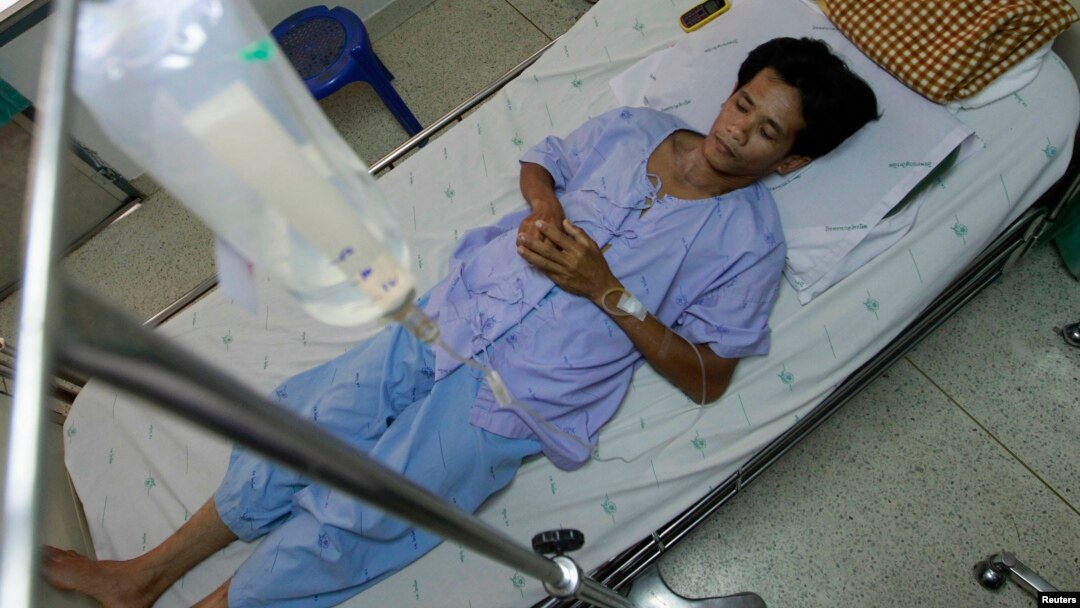 FILE - San Petchrod, 47, lies in bed where he is being treated for malaria at Sai Yoke hospital, Kanchanaburi Province, Thailand, Oct. 26,2012. 