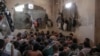 FILE - Suspected Islamic State members sit inside a small room in a prison south of Mosul, July 18, 2017. 