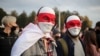 FILE - People attend an opposition rally to reject the Belarusian presidential election results in Minsk, Belarus. Oct. 25, 2020. 