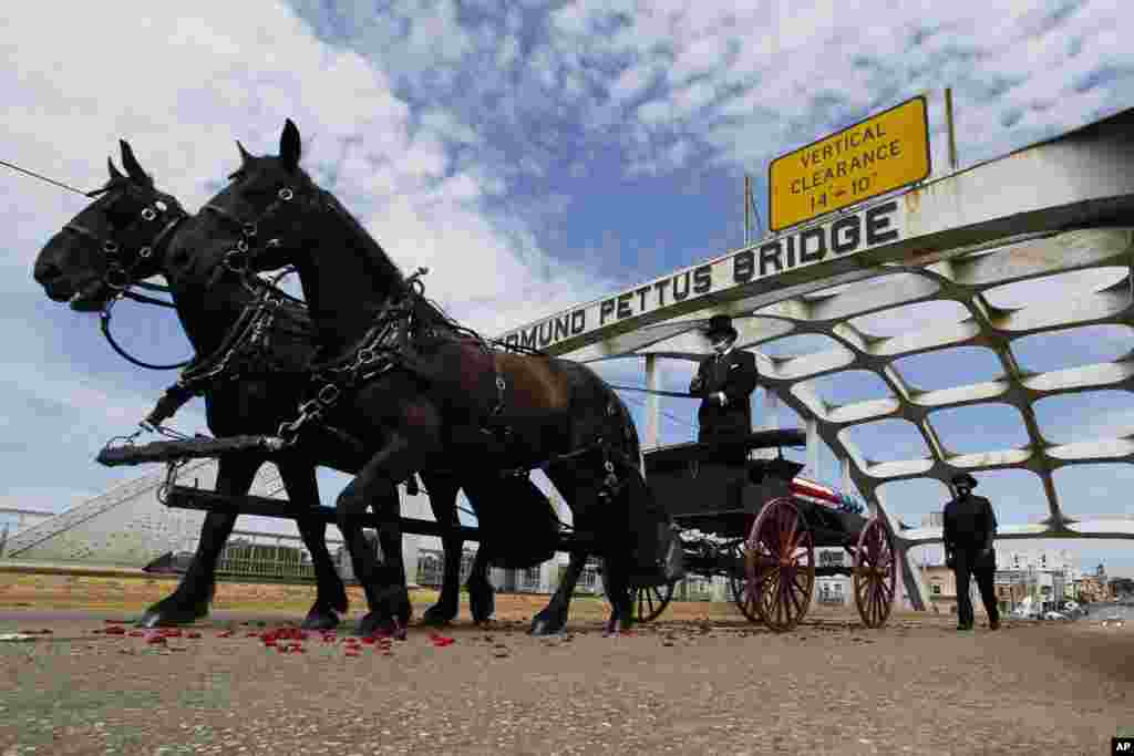 The casket of Rep. John Lewis, a pioneer of the civil rights movement and long-time member of the U.S. House of Representatives, moves over the Edmund Pettus Bridge by horse drawn carriage during a memorial service in Selma, Alabama.