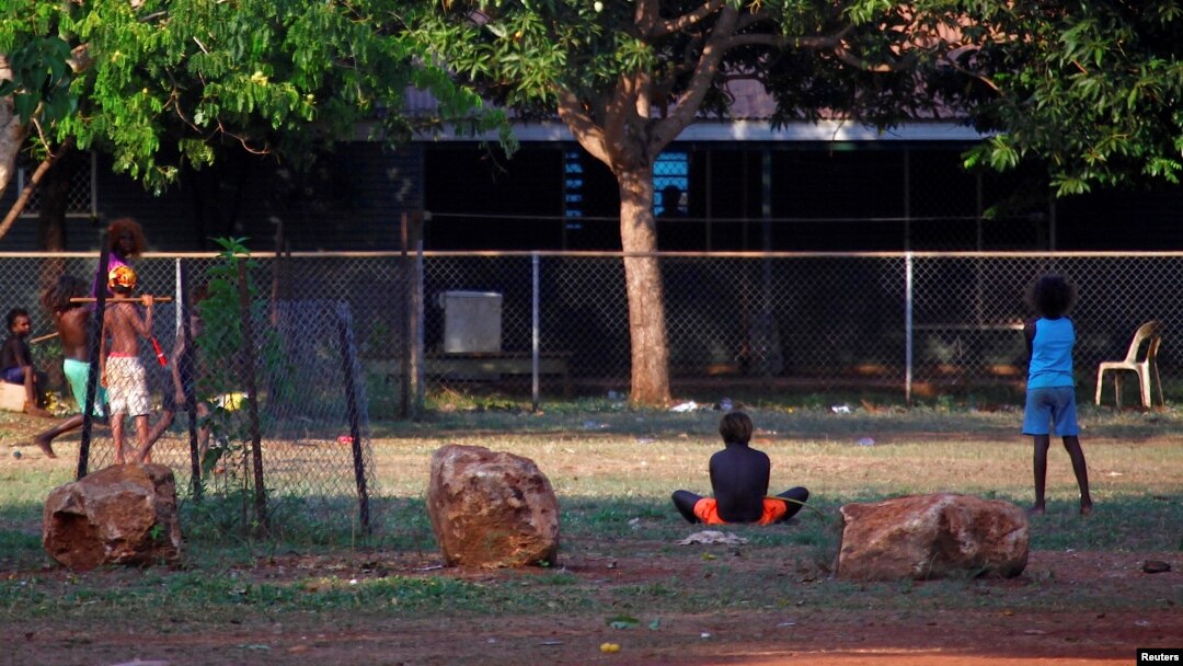 Members of the Australian Aboriginal community of Ramingining can be seen near their homes in East Arnhem Land, located east of the Northern Territory city of Darwin, Australia, Nov. 24, 2014.