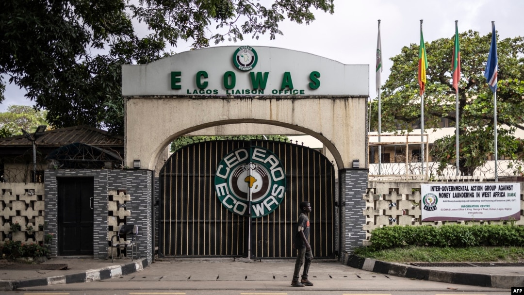 FILE - A local resident walks past the Economic Community of West African States (ECOWAS) office in Lagos, Nigeria, Sept. 24, 2024.