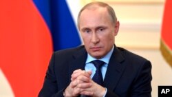 President Vladimir Putin answers journalists' questions on current situation in Ukraine at the Novo-Ogaryovo presidential residence outside Moscow, March 4, 2014. 