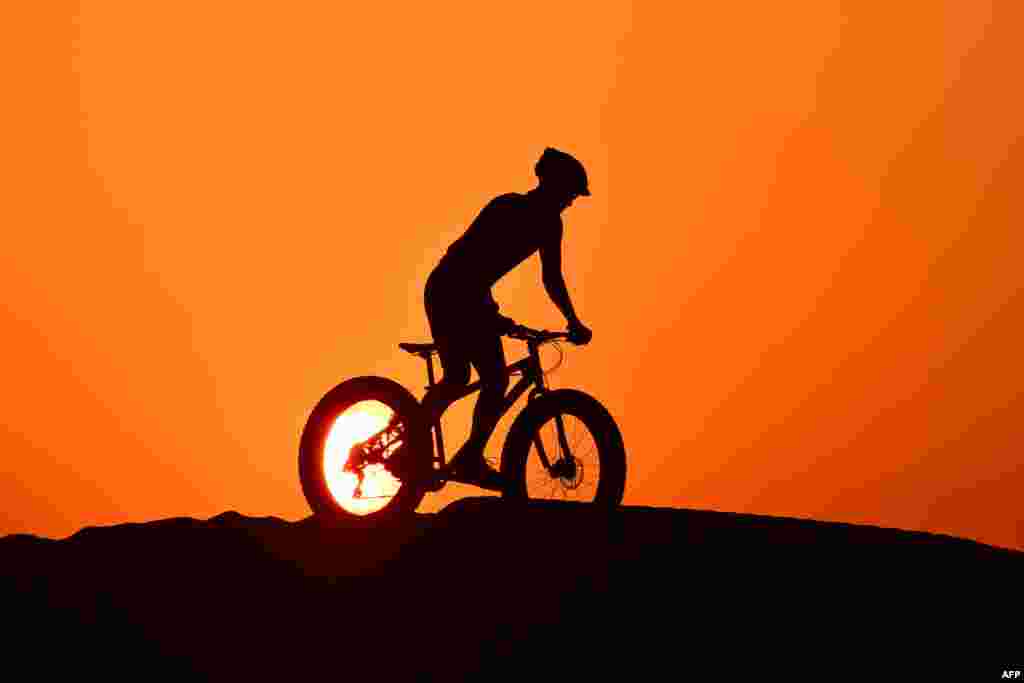 A cyclist rides in al-Qudra desert in the Gulf emirate of Dubai, United Arab Emirates, June 8, 2020.