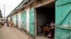 A man works in a shop while others are closed at the Ajara Market due to low sales in Badagry, near Lagos, Sept. 6, 2019. A wave of kidnappings in Nigeria is being blamed largely on economic hardship.