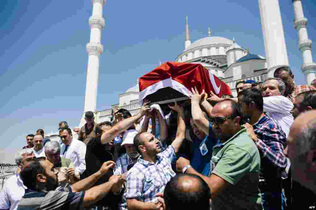 People carry the coffin of Sehidmiz Murat Inci, a victim of the coup attempt, during his funeral ceremony at the Kocatepe Mosque in Ankara, Turkey.