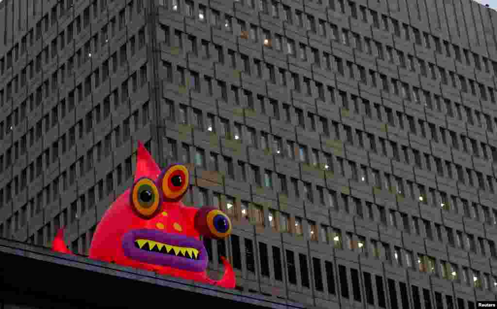 A giant inflatable monster, one of a collection of monsters that have appeared to mark Halloween, is seen in front of an office block in Manchester, Britain.