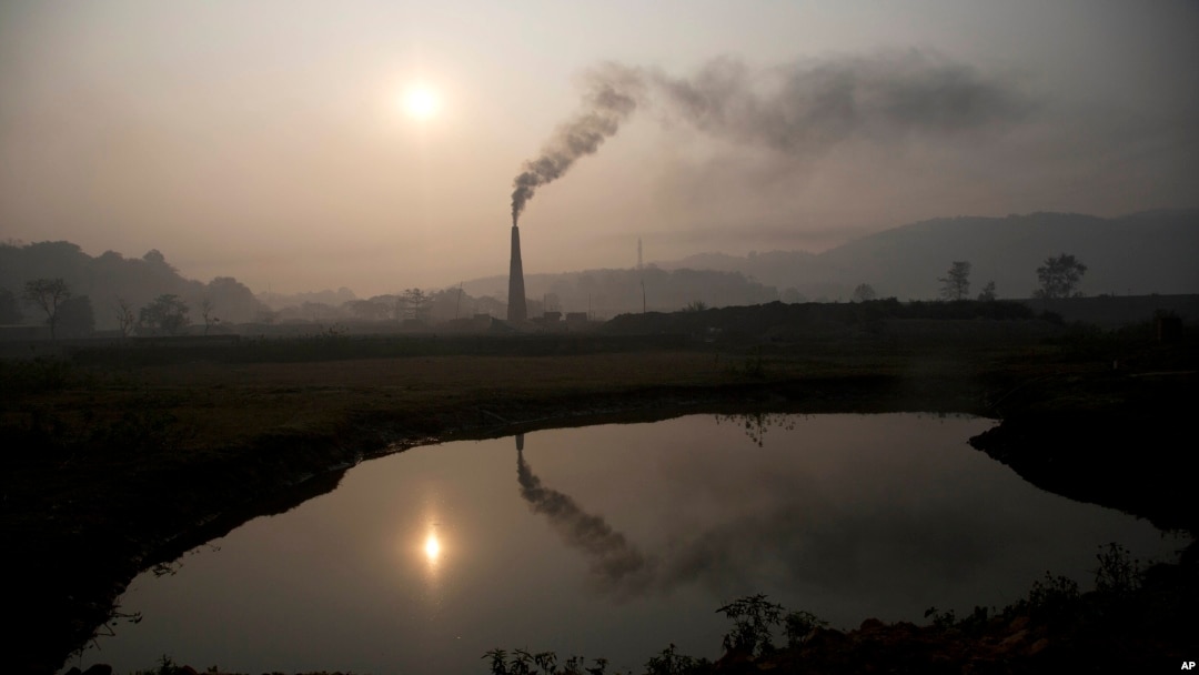 Smoke rises from a brick kiln on the outskirts of Gauhati, India, Jan. 26, 2015.