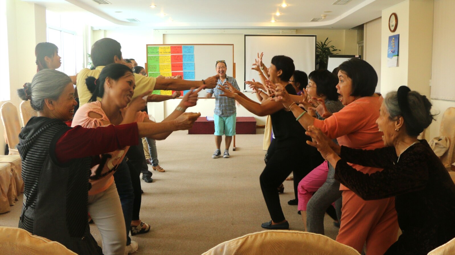 Participants react at a Parents, Families and Friends of Lesbians and Gays meeting in Vietnam.