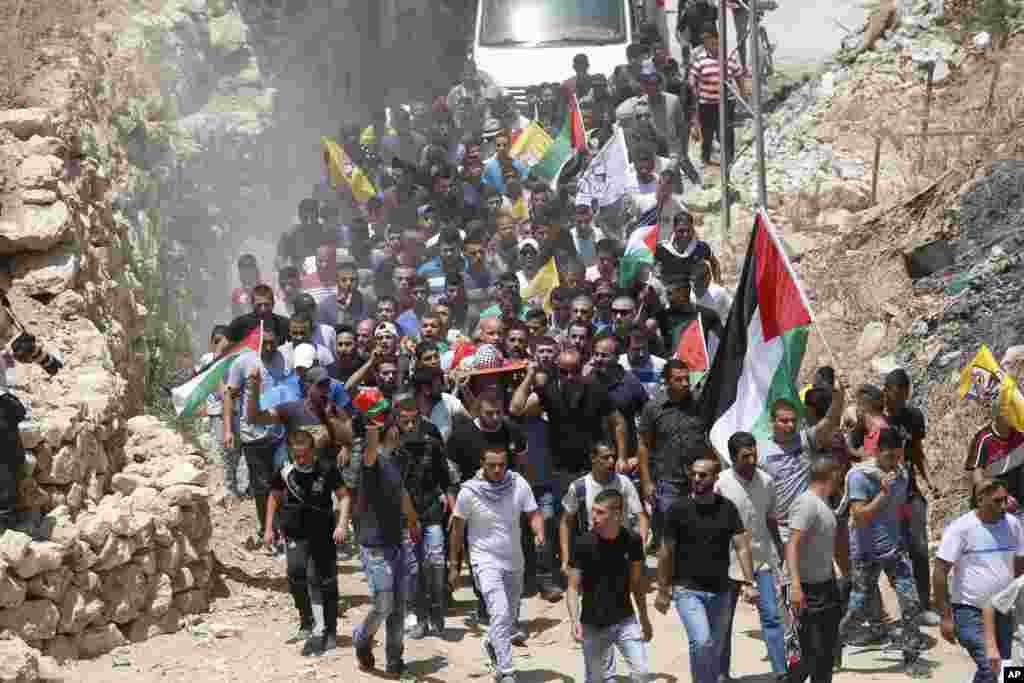 Mourners carry the body of Muhey al-Tabakhi, 12, during his funeral in the West Bank town of Al-Ram, near Jerusalem. A Palestinian hospital official said the boy was killed after clashes erupted between Israeli forces and protesters in the West Bank.