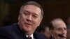 FILE - CIA Director-designate Rep. Michael Pompeo, R-Kan, accompanied by former Senate Majority Leader Bob Dole, testifies on Capitol Hill in Washington, Jan. 12, 2017, at his confirmation hearing before the Senate Intelligence Committee. 