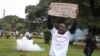 FILE - Demonstrators run from tear gas fired by police at a protest against corruption, in downtown Nairobi, Kenya, on Aug. 21, 2020. A report released by the U.S. trade office on March 29, 2024, said that senior government officials demand bribes before awarding contracts.