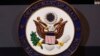 The seal of the State Department is seen on the podium as Secretary of State Mike Pompeo makes a statement about refugees to the media, Sept. 17, 2018, at the State Department in Washington.
