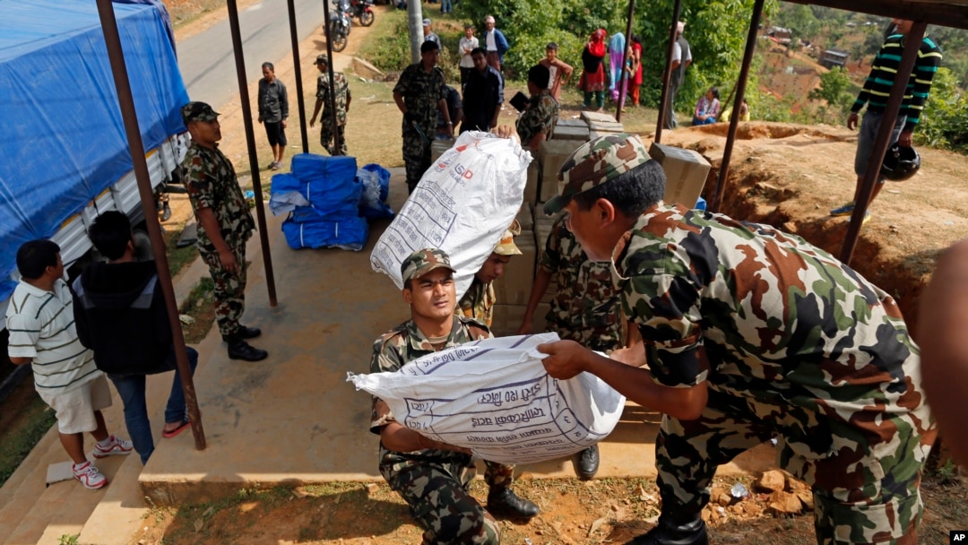 Nepalese soldiers load USAID relief sacks at a staging area near Saturday's massive earthquake's epicenter in the town of Gorkha, Nepal, April 28, 2015. 