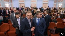 Members of Jehovah's Witnesses wait in a court room in Moscow, Russia, on April 20, 2017. Russia's Supreme Court has banned the Jehovah's Witnesses from operating in the country, accepting a request from the justice ministry.
