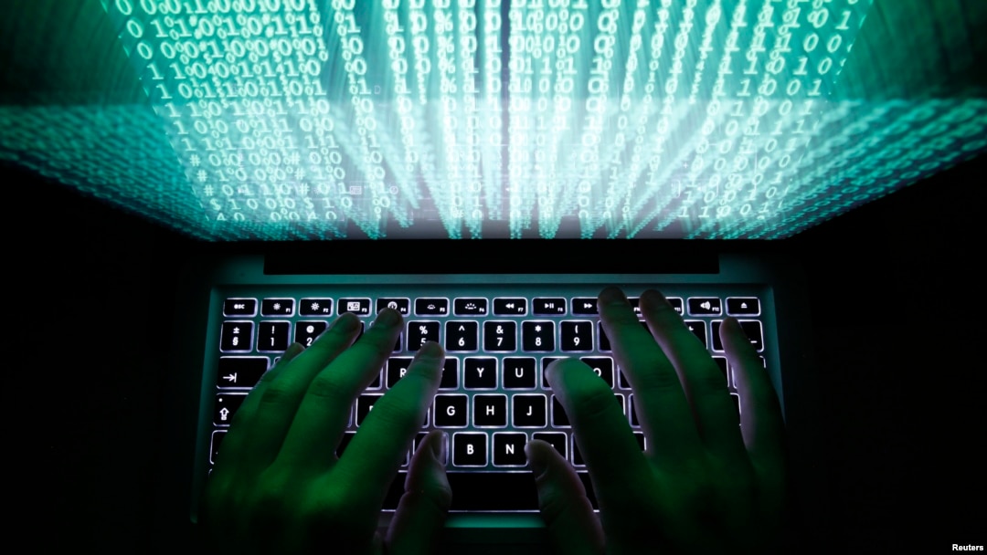 FILE - A man types on a computer keyboard in Warsaw.